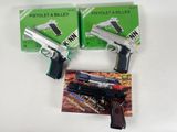 two guns that are sitting next to each other on a table