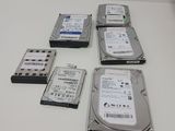 four hard drives sitting on top of a white table next to each other