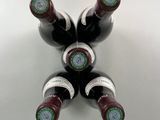 four bottles of wine are arranged in a star shape