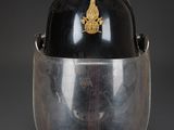 an old helmet with a gold emblem on the side of it