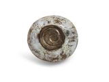 a close up of a metal object on a white surface