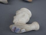a small statue of a person with a tag on it