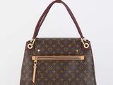 a louis vuitton handbag on a white background