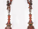 pair of red and gold candlesticks with cherenshes on them