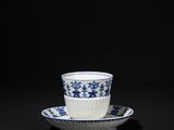 blue and white cup and saucer on a black background