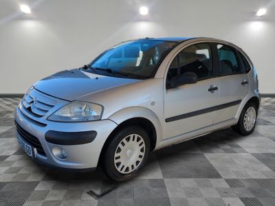a picture of a silver car parked in a garage