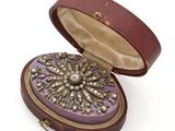 an image of a purple box with a broochet inside of it
