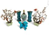 four vases and a dragon figurine sitting next to each other