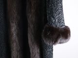 a close up of a fur coat hanging on a wall