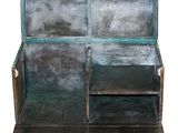 an old wooden bench with metal panels on the back of it