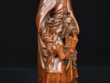 a wooden statue of a woman holding a child