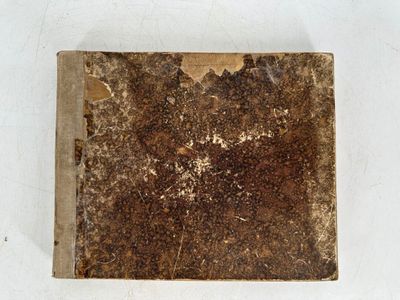 an old book that is sitting on a table