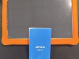 an orange and blue tablet computer sitting on top of a black table