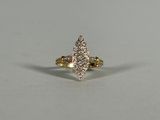 a yellow gold ring with diamonds on a white background
