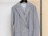 the jacket is hanging on a hanger next to a coat rack