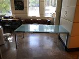 a glass table in the middle of a room