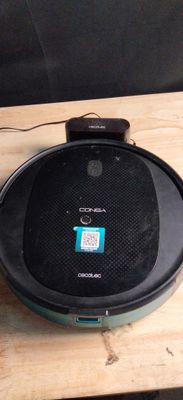 a black speaker sitting on top of a wooden table