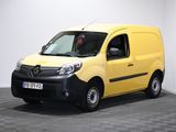 La camionnette jaune est garée dans une pièce blanche au sol carrelé.