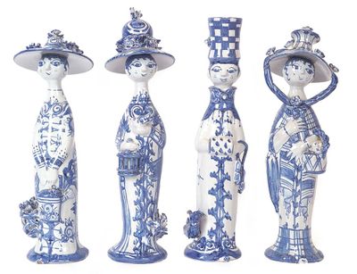 four blue and white figurines of women with hats and flowers