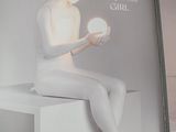 a book with a picture of a woman sitting on a table