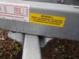 a close up of a metal fence with a sign on it