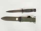two knives are laying next to each other on a white surface