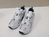 pair of new balance shoes on a white table