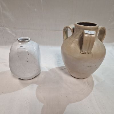 two vases sitting next to each other on a table