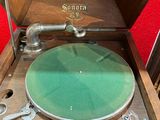 a record player sitting in a wooden box on a table