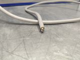 a white cord connected to a white cord on a table