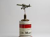 a small tin with a plane on top of it