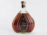 a close up of a bottle of brandy on a white surface