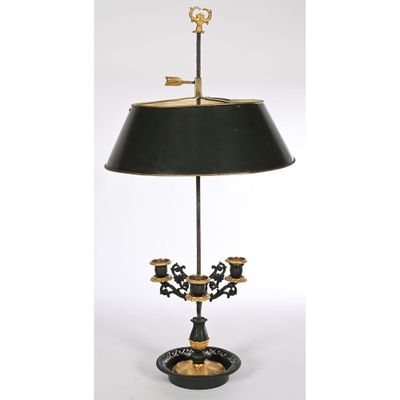 a black and gold table lamp with a black shade