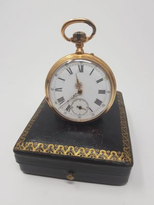 a small black box with a gold clock on top of it