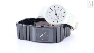 a white watch sitting on top of a black watch band