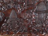 carvings of people and animals are carved into a wood panel
