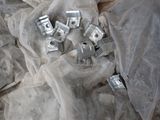 many pieces of metal sitting on a sheet of plastic