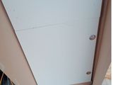 a white refrigerator sitting in the corner of a room