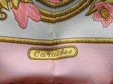 a close up of a pink dress with a gold trim