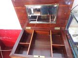 a wooden box with a mirror on top of it