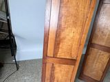 two tall wooden cabinets sitting next to each other on the floor