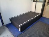 a mattress on the ground in front of a door