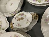 a lot of plates and bowls that are on a table