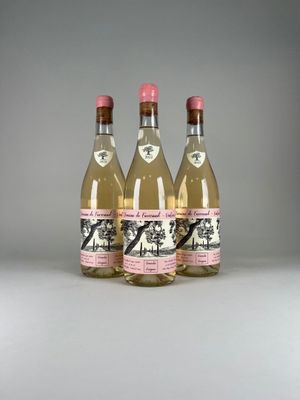 three bottles of wine sitting next to each other on a table