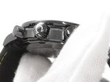 a close up of a watch on a white glove