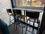 four chairs sitting at a table in front of a window