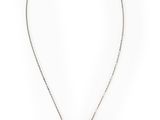 un collier noir et blanc avec un pendentif circulaire monté sur une chaîne