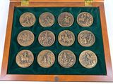 a wooden box with a set of twelve coins in it
