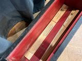 a red box that has some wooden sticks in it