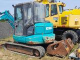 a blue and yellow excavator and a yellow and black bulldozer in a field